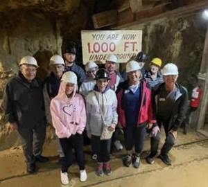 Group of people in hardhats in a cave.